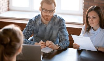 Man and Woman interviewing another man