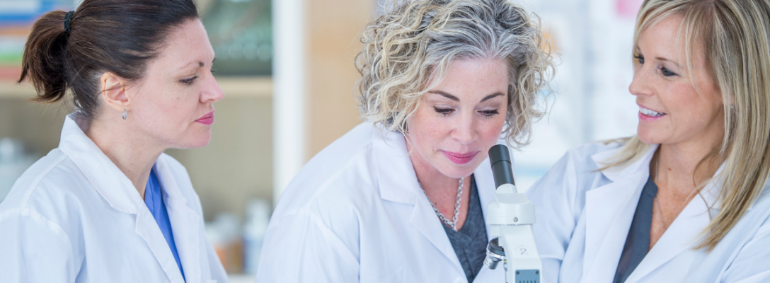 IP Blog images (in text) (2) three women in labcoats working analysing through microscope life sciences