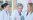 three women in labcoats working analysing through microscope life sciences