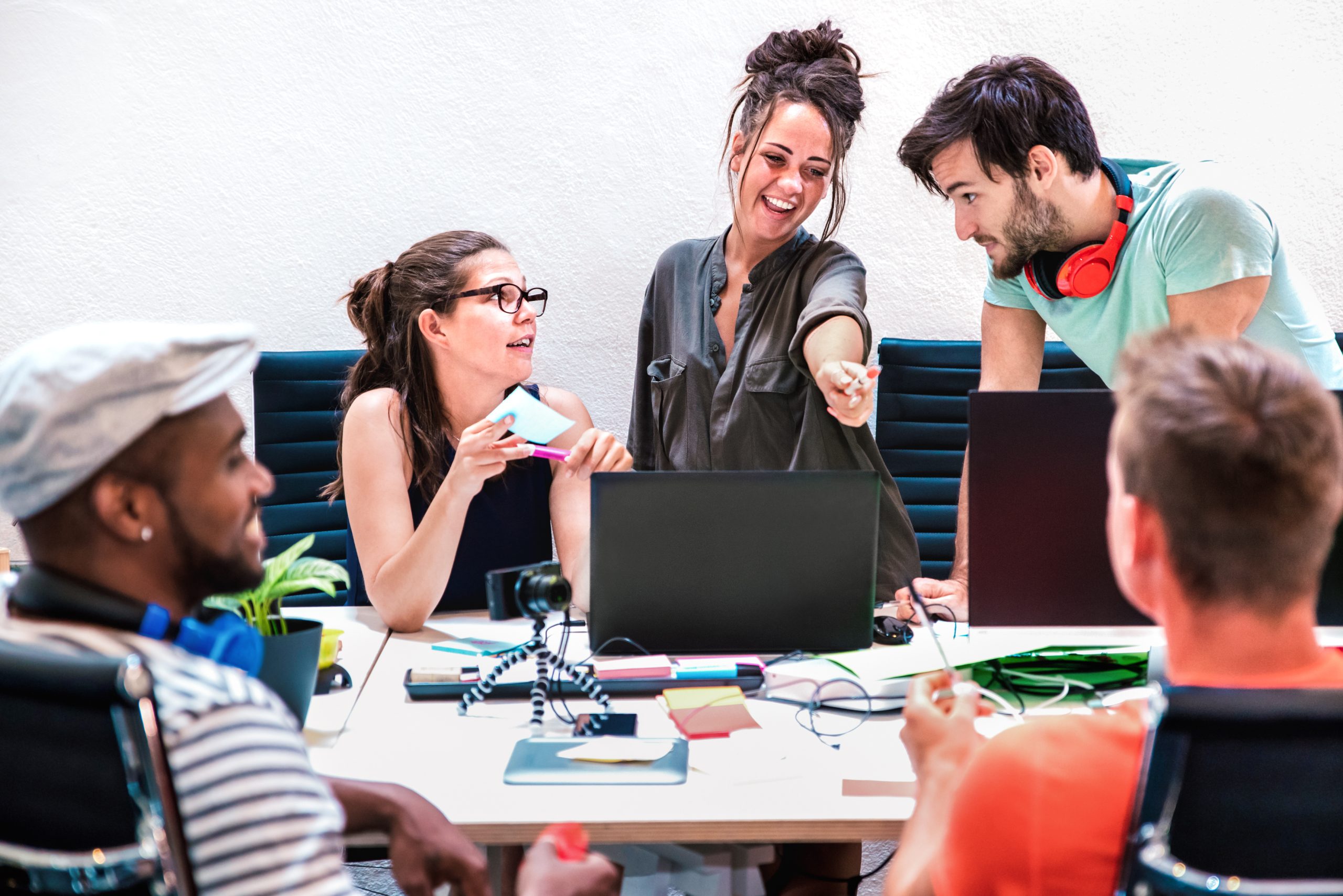 Millenial friends employees group workers on computer at startup How to attract Gen Z candidates to your IT roles